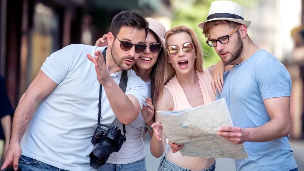 Happy tourists trying to find a destination on a map.