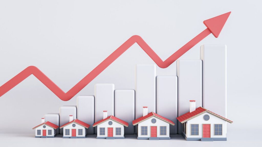 Illustration of increasing real estate market trends with a red upward arrow, showing various small houses growing in size along a bar graph.