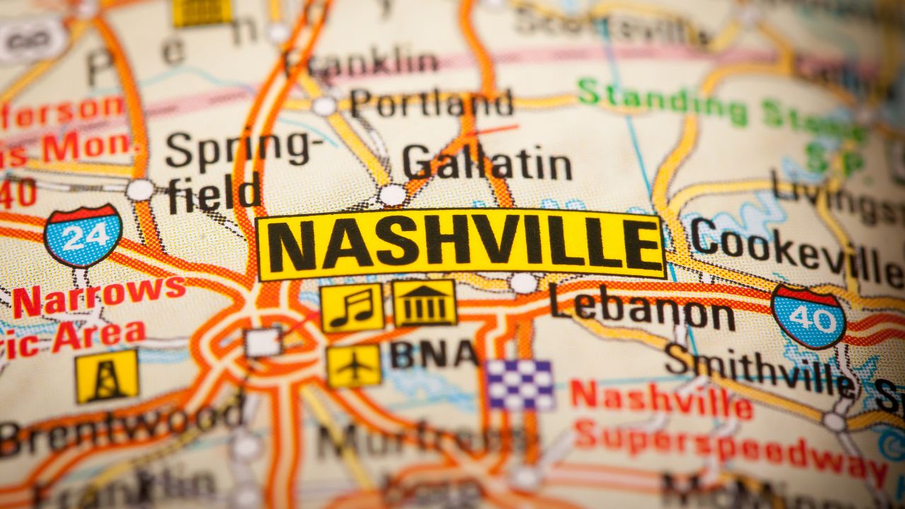 Close-up of a colorful map highlighting Nashville, Tennessee, with surrounding areas such as Lebanon, Cookeville, Springfield, and Brentwood clearly labeled. Icons representing music, landmarks, and the airport are visible near the city name.