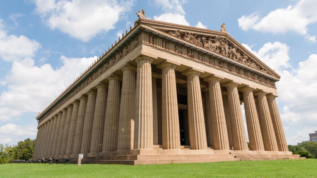 A close-up view of the full-scale Parthenon replica with tall columns and sculptures.