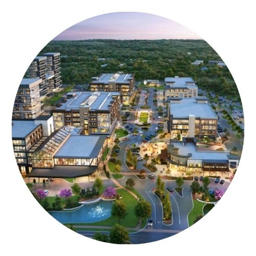 Aerial view of a modern mixed-use development with shops, offices, and green space.