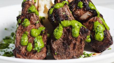 Grilled lamb chops topped with green herb sauce.