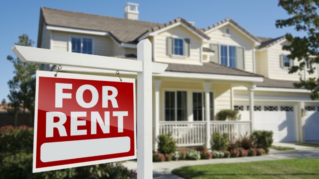 House with a red "FOR RENT" sign in front.