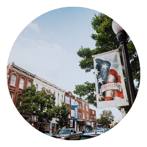 Downtown Franklin street with historic buildings and a banner.