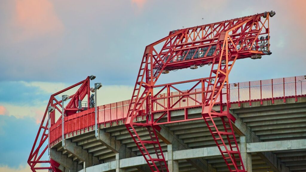 Red steel structure on the side of a stadium.