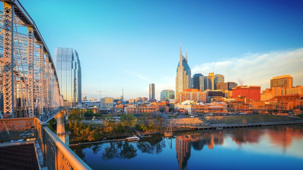 A view of downtown Nashville’s skyline at sunrise from a pedestrian bridge.