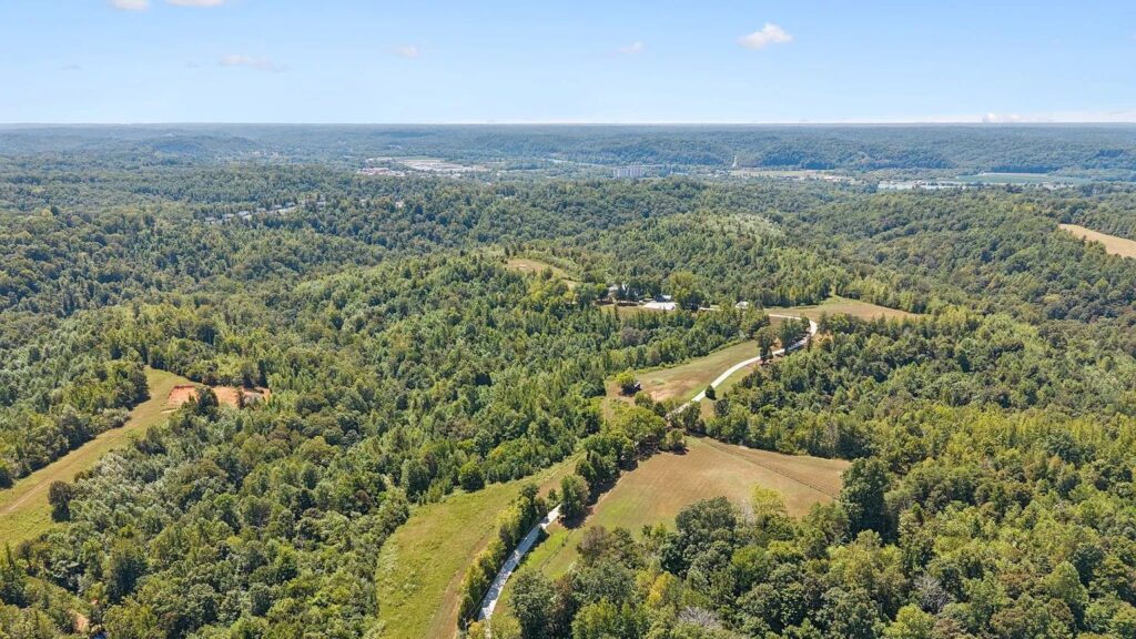 Aerial view of rolling wooded hills and rural land in Ashland City, Tennessee.