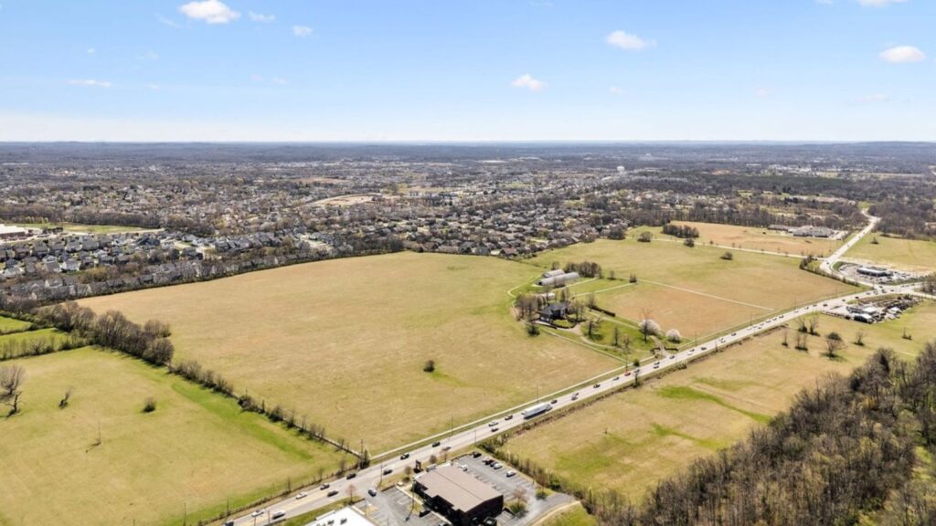 Aerial view of open farmland and suburban development in Spring Hill, Tennessee.